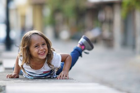 A very pretty 4 year old girl who smiles and plays