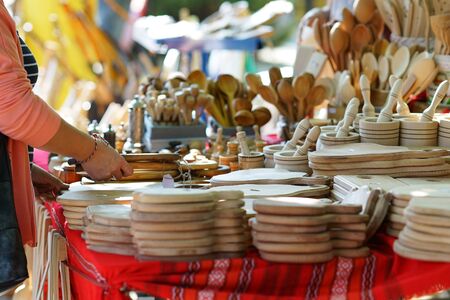Detail of the hands of a buyer choosing a wooden cradleの写真素材