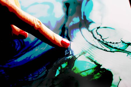 Woman finger indicating an abstract color background with posterization graphic elaborationの写真素材