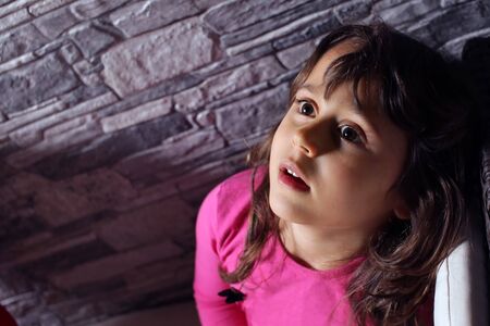 a 5 year old girl looks up at the moon and the stars,copy space