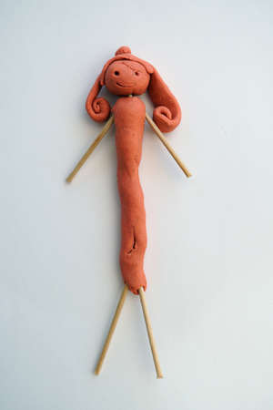 creation of a doll with plasticine made by a 5 year old girl, isolatedの写真素材