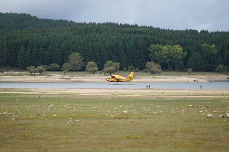 Camigliatello Silano, Calabria, Italy October, 18 2020. A plane of the fire brigade picks up water from Lake Cecita, in the Sila National Park in Calabriaのeditorial素材