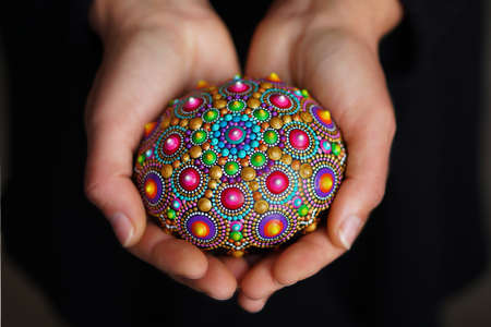 Beautiful Hand Painted Mandala holding in hands