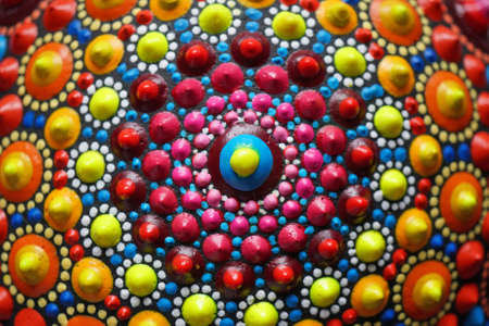 Beautiful colorful hand painted dot mandala on gray background, isolatedの写真素材
