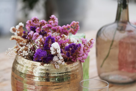 Beautiful decoration with flowers and colorful glass vases, selective focusの写真素材