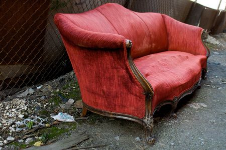 Abandoned Red Couch in an Alleyの写真素材