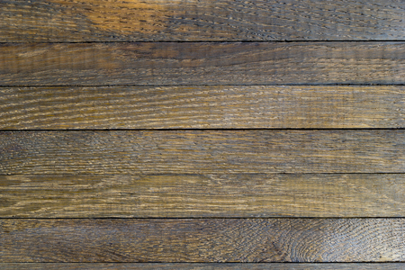 Horizontal wooden table background. Old dark brown burnt oak. Top view. Copy space. Close up. Natural surface texture. Horizontal lines from thin planks.の写真素材