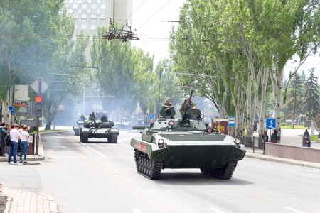 Donetsk, Donetsk People Republic, Ukraine â May 9, 2019: Soviet assault vehicle, armored tanks T-72 and different military technics driving on Artema street in the end of Victory Day Parade.のeditorial素材