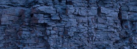Rock cliff face background. Toned. Copy space for user text. Abstract texture for stone mining...