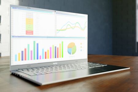 Enterprise financial report with graphs and charts on a screen of modern laptop on wooden table....