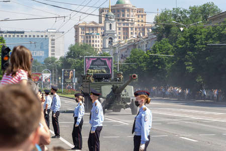 Donetsk, Donetsk People Republic, Ukraine, June 24, 2020: A convoy of military vehicles with Soviet artillery guns on a trailer moves along Artyom Street during the Victory Day parade in World War II.のeditorial素材