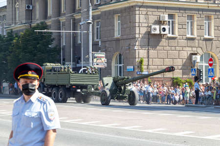 Donetsk, Donetsk People Republic, Ukraine, June 24, 2020: A convoy of military vehicles with Soviet artillery guns on a trailer moves along Artyom Street during the Victory Day parade in World War II.のeditorial素材