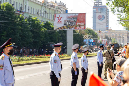 Donetsk, Donetsk People Republic, Ukraine, June 24, 2020: A convoy of military vehicles with Soviet artillery guns on a trailer moves along Artyom Street during the Victory Day parade in World War II.のeditorial素材