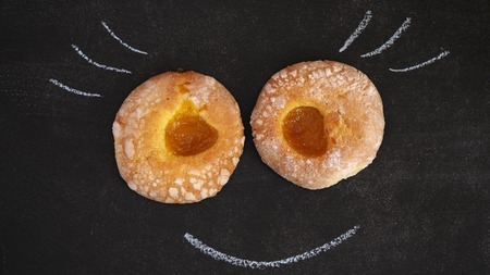Chalk painted eyelashes and smile. The face of an unusual character from bakery products. Close upの写真素材