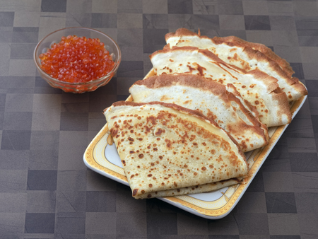 Nutritious healthy food with vitamins and minerals. Breakfast, lunch or dinner fried pancake with caviar of red fish. Close upの写真素材