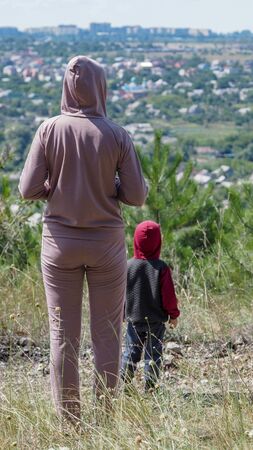 Mom son overlooking city for concept design.の写真素材