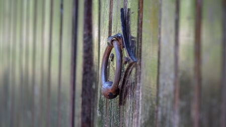 old metal handle on a wooden doorの写真素材