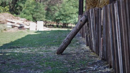 A large log supports the wooden fence of the Stockmanの写真素材