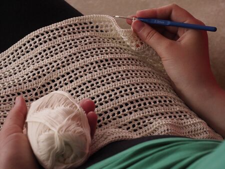 A woman works with delicate laceの写真素材