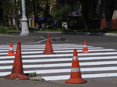 White traffic markings with a pedestrian crossing on a gray asphaltの写真素材
