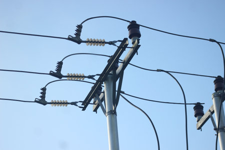 electricity post with blue sky background, closeup of photo.の写真素材