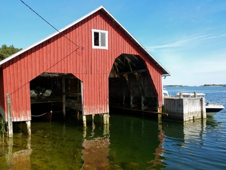 Traditional red boat house in Brnnskr island in the Turku archipelago at Baltic Sea Finlandの素材