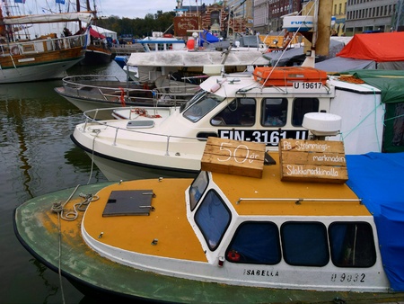 Fishing boats in the Helsinki harbor at Kauppatori during the Helsinki Baltic Herring Fairの素材