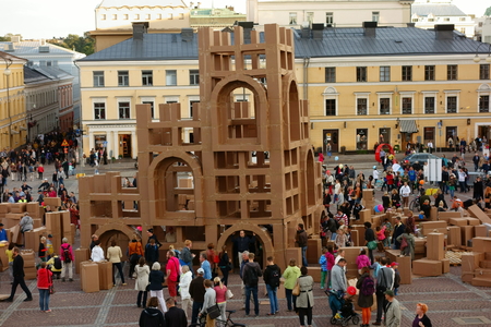 Helsinki, Finland - August 21, 2014 - Large crowd of people constructing cardboard skyscrapers together by using cardboard and tape at the Senate Square in the center of Helsinki, Finland at the annual Night of Arts event which is part of the Helsinki Fesのeditorial素材