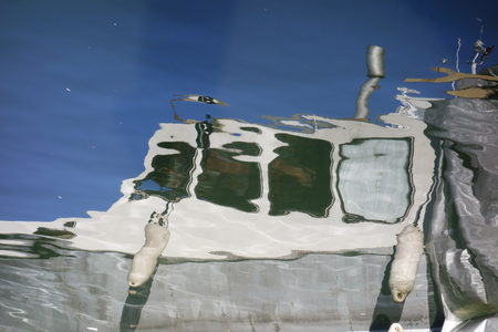 Reflection of a white fishing boat from sea water in Helsinki, Finland during Helsinki Baltic Herring Fair in 8 October 2015.の写真素材