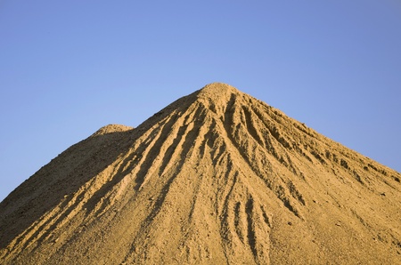 Sand pile with blue skyの写真素材