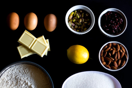 Food ingredients on black background. Preparing biscotti.の写真素材