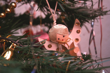 Vintage Christmas decoration on the tree - little angel singing Christmas carols.の写真素材