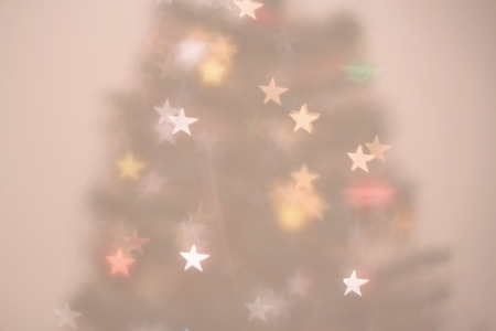Christmas tree defocused background with star-shaped bokeh.の写真素材