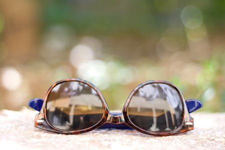 Brown round sunglasses outdoor, in summer. Selective focus.の写真素材