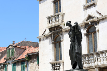 Sculpture of historic Croatian writer and poet Marko Marulic on Square of the Radic brothers Fruit square in Split Croatia.の写真素材