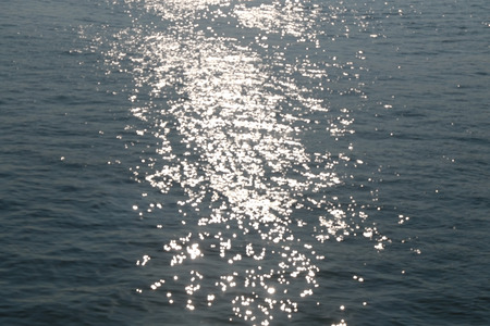 Sunlight illuminated in the sea - abstract defocused background.の写真素材