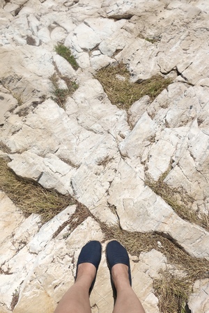 Feet in espadrilles on rock.の写真素材
