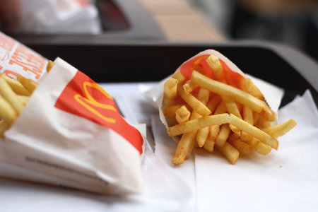 Split, Croatia - February 26, 2015: Two portions of McDonald's french fries, one of the most popular fast food around the world. Selective focus.のeditorial素材