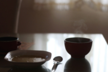 Lunch on the table with dim light and steam. Defocused.の写真素材