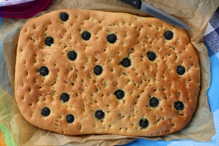 Homemade mediterranean bread with olives, served on a picnic. Top view.の写真素材