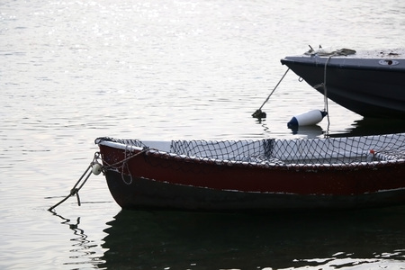 Two small fishing boat in shallow sea. Selective focus.の写真素材