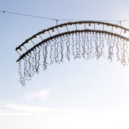 Christmas decoration on a street, illuminated by winter sun.の写真素材