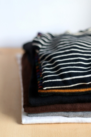 Pile of folded sweaters. Selective focus.
