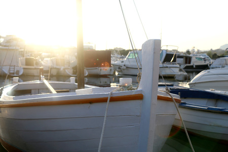 Small white wooden boat in a port. Close-up, selective focus.の写真素材