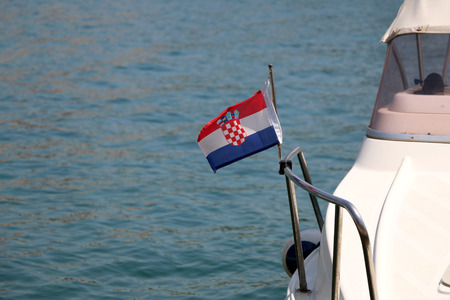 Small Croatian flag on a boat, blowing in the wind. Selective focus.の写真素材