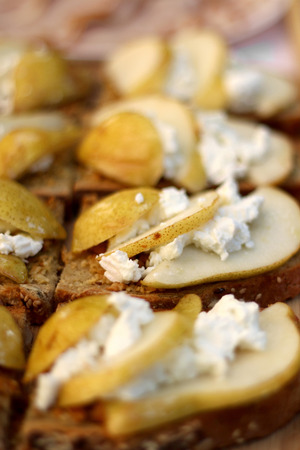 Slices of whole wheat bread with goat cheese and pears. Selective focus.の写真素材