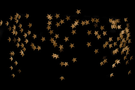 String lights shaped like stars. Defocused festive background.