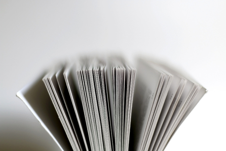 Open book, close-up on pages. Selective focus, white background.の写真素材