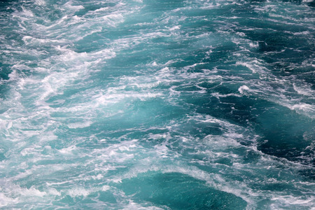 Sea foam oon a water surface. Beautiful blue color. Selective focus.の写真素材