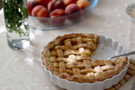 Homemade baked peach pie, served on a table. Selective focus.の写真素材